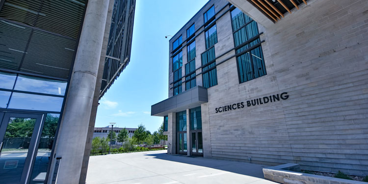 Building facade with metal letters that read Sciences Building.